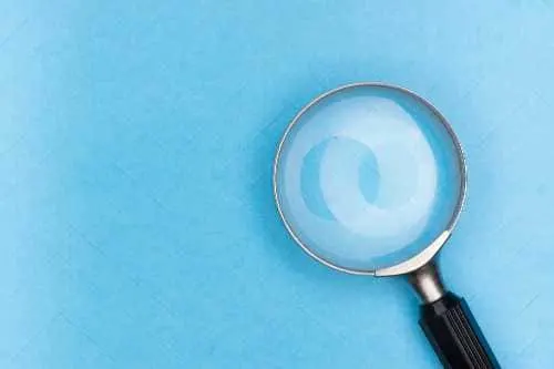 Search engine success with solid keyword research illustrated with a magnifying glass